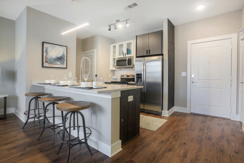 Helios - Kitchen With Stainless Steel Appliances And Chef’s Table-Sized Kitchen Island